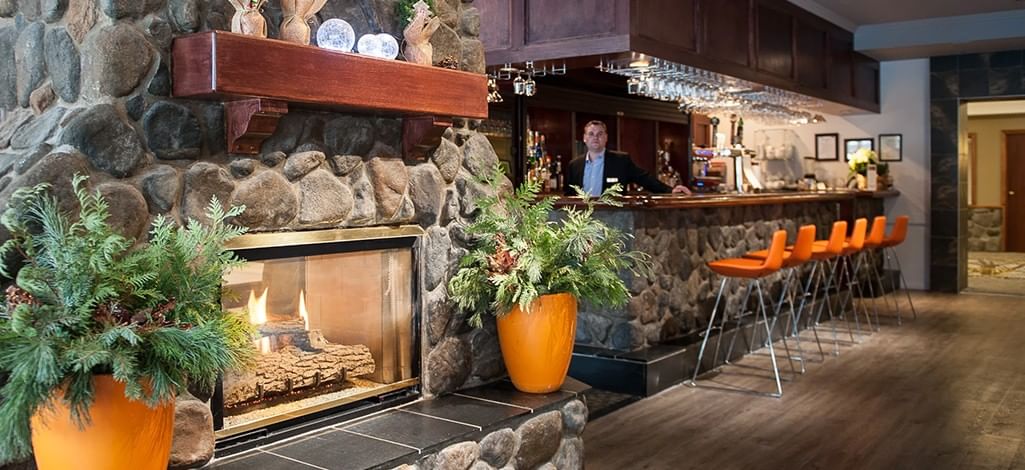 A cozy fireplace bar in Canmore decorated for Christmas.