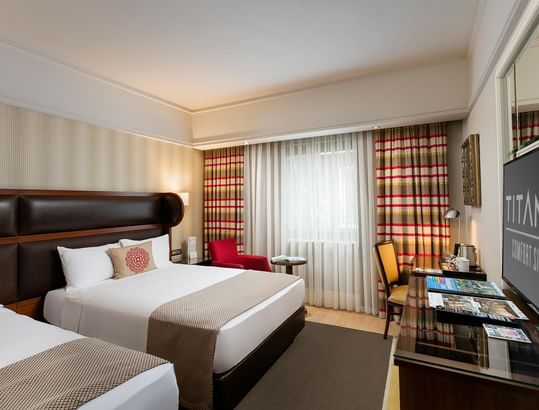 Interior of family Room with two beds, working table & a TV in Titanic Comfort Sisli