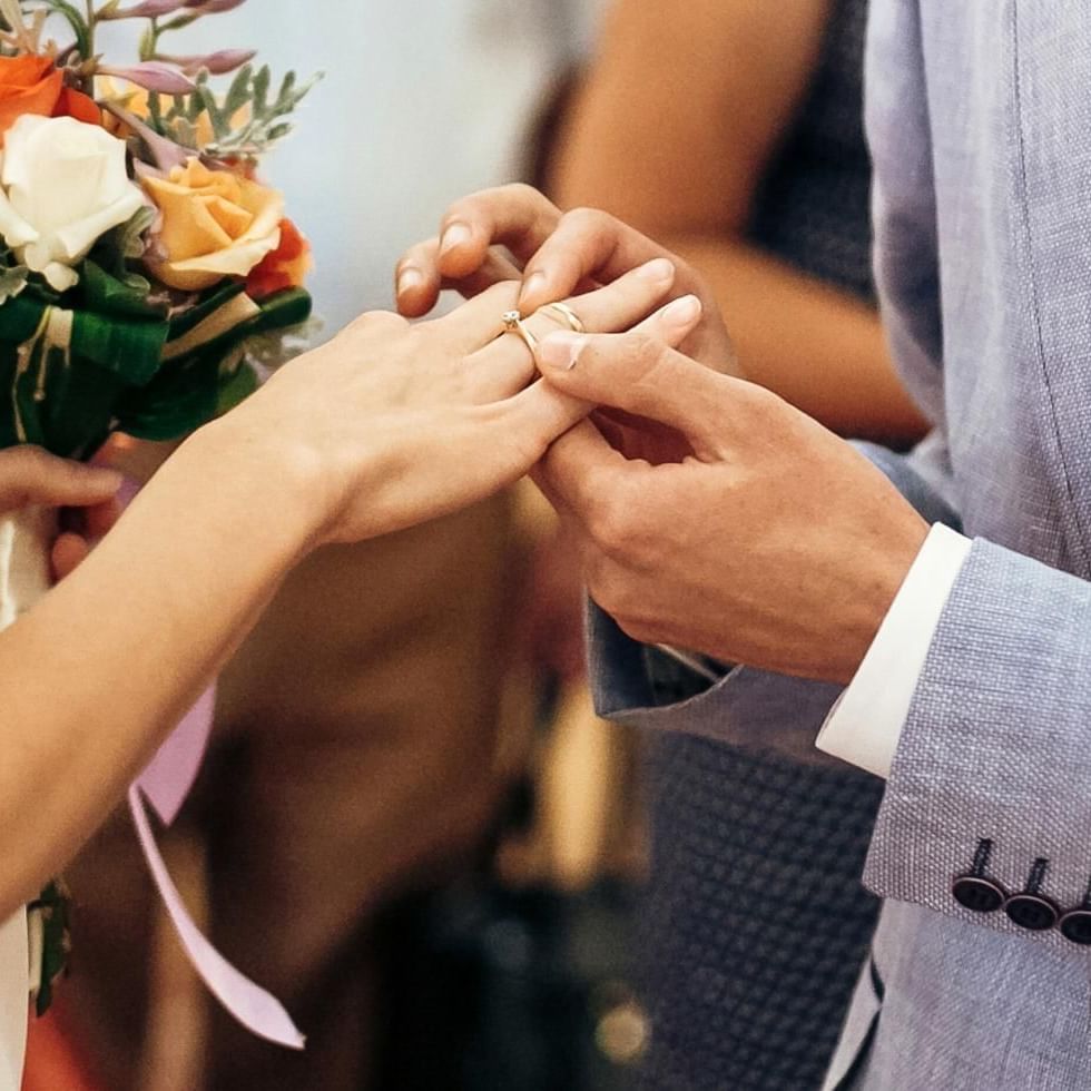 Couple exchanging rings during marriage ceremony