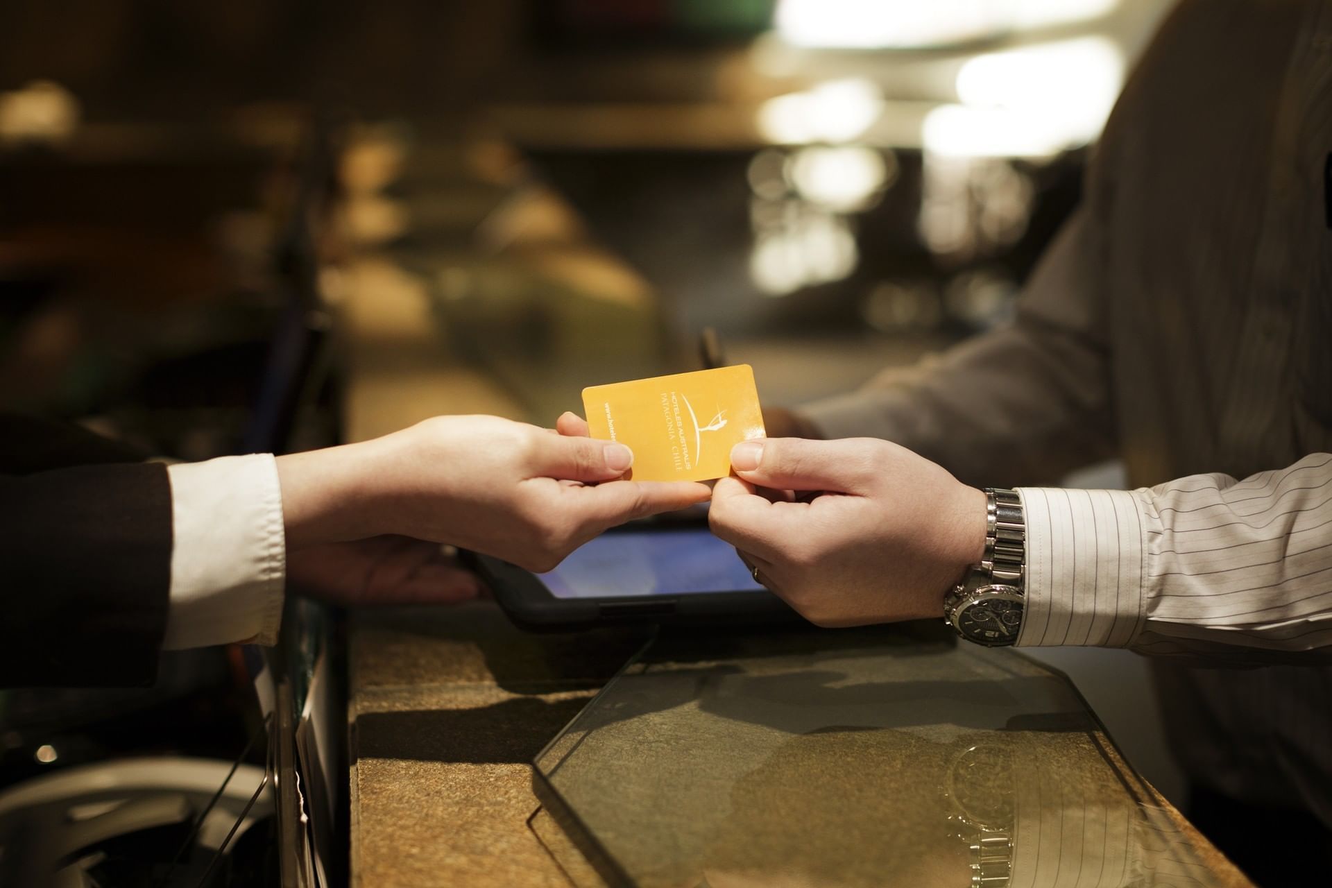 A person hand overring a visiting card at Hotel Cabo de Hornos