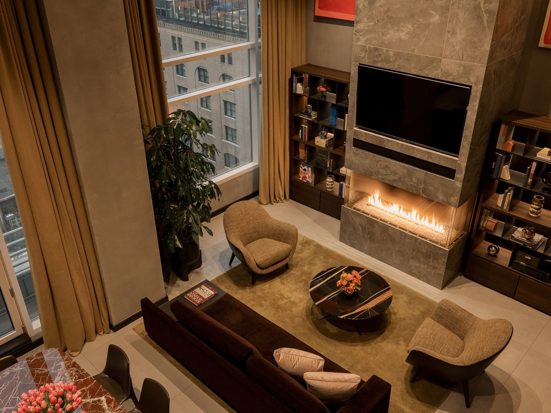 The Football Suite with fireplace, large windows, and comfortable seating.