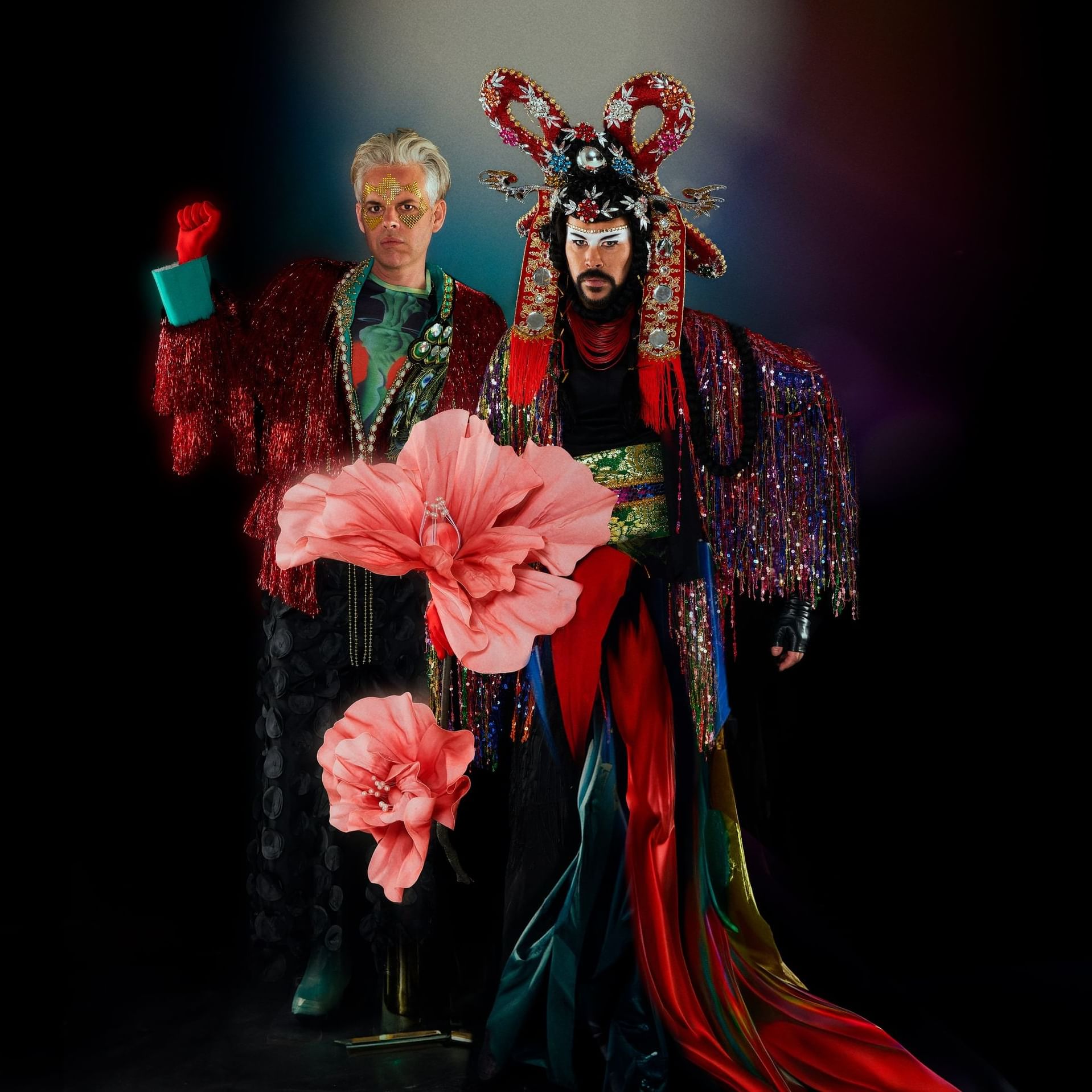 Two men in colorful costumes adorned with flowers at Royal on the Park Hotel