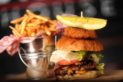 Burger and fries served at Peanuts in Carriage House Hotel