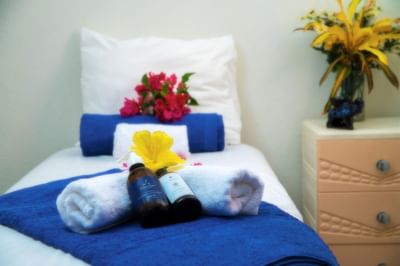 Spa amenities & mini towels with flower décor on spa bed in the Spa at Dover Beach Hotel