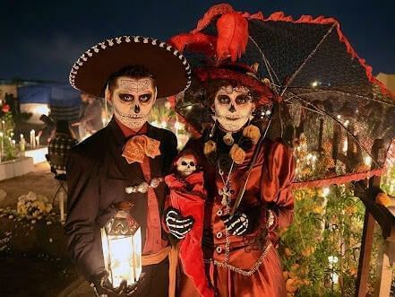 A couple in Halloween costumes, posing outdoors at Fiesta Inn