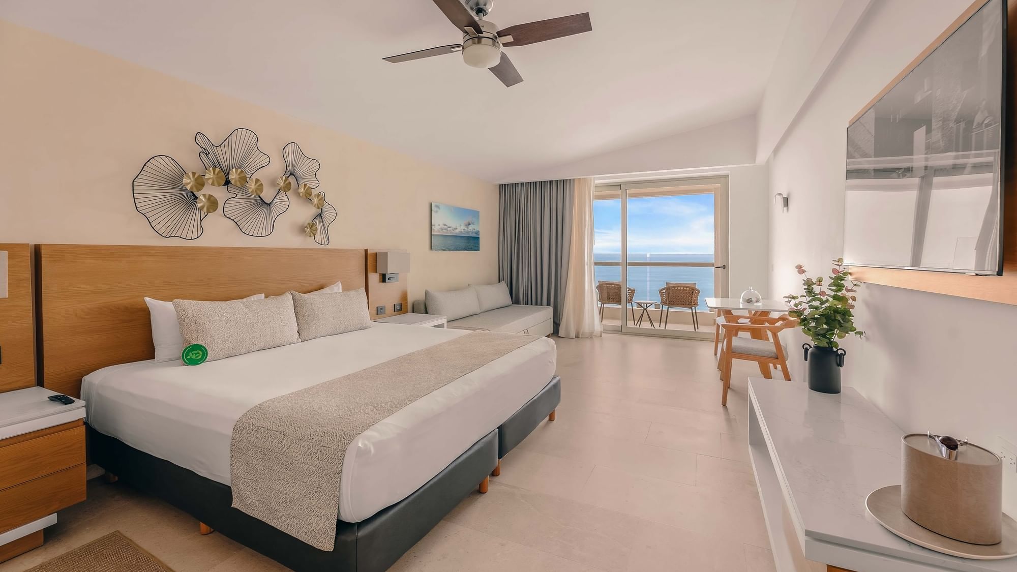 Bright Premium Suite at Sunset Plaza Beach Resort, with a king bed, living area, and balcony with ocean views