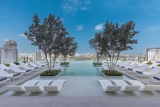 Outdoor swimming pool with pool beds at Eastin Hotels