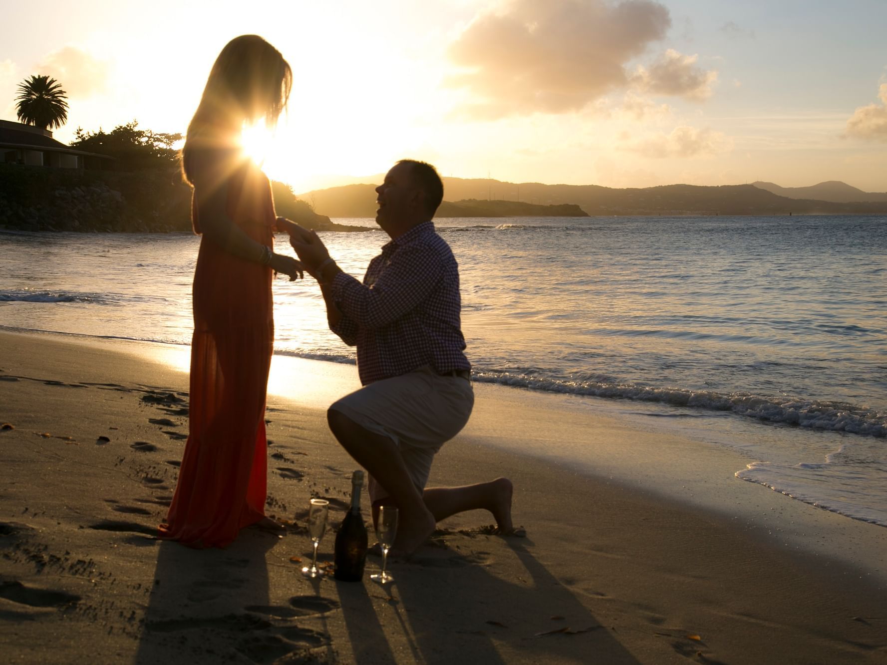A marriage proposal on the beach in Buccaneer Hotel at sunset