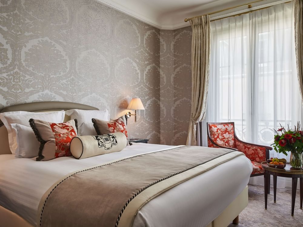 Bed with couch near window in Deluxe Suite Belle Époque at Hotel Westminster Paris