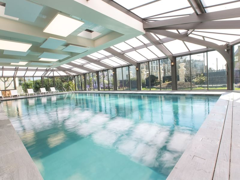 Indoor pool with outdoor view at Le Grand Hôtel des Thermes