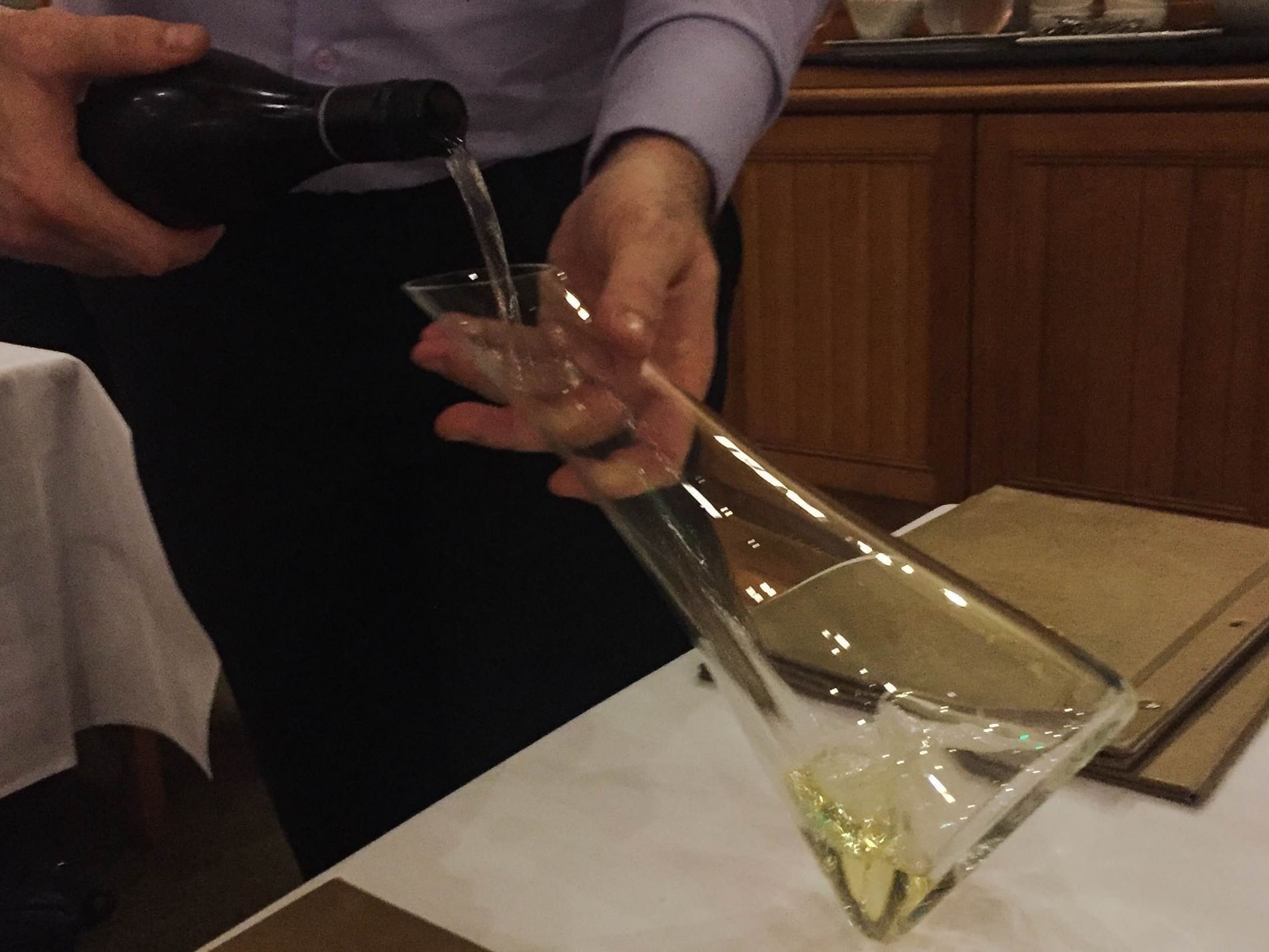 Man pouring champagne into a vessel at the Freycinet Lodge