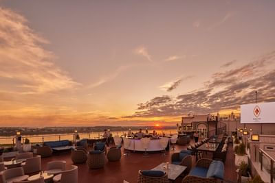 Dining tables arranged in 360@Eleven with a sunset view at Eastin Vientiane Laos