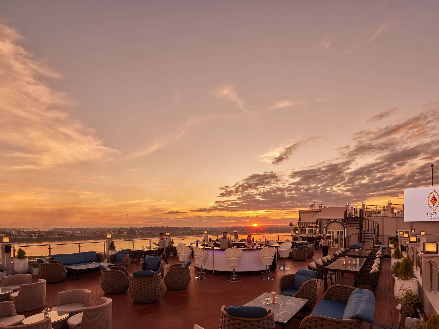 Dining tables arranged in 360@Eleven with a sunset view at Eastin Vientiane Laos