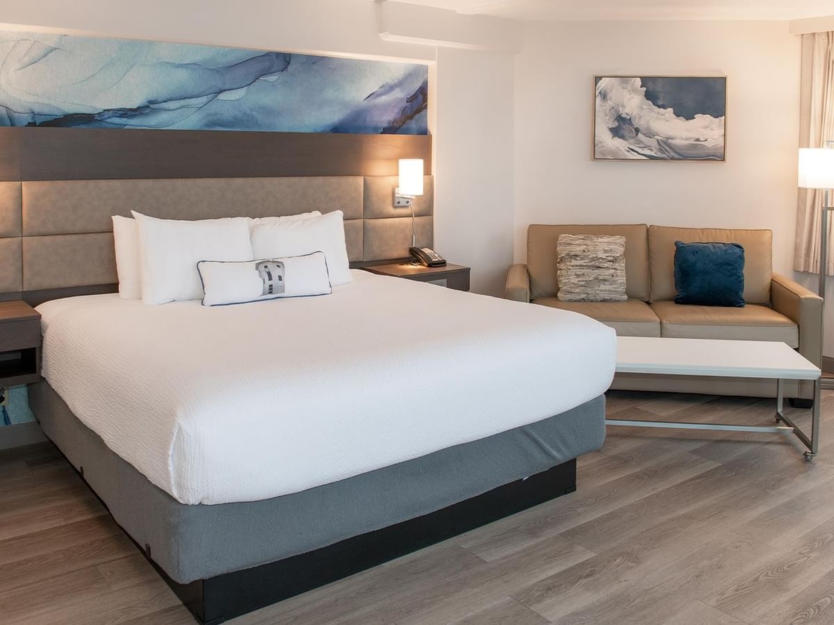 King bed and sofa in Coast Premium King room with ocean view at Coast Bastion Hotel in Nanaimo.