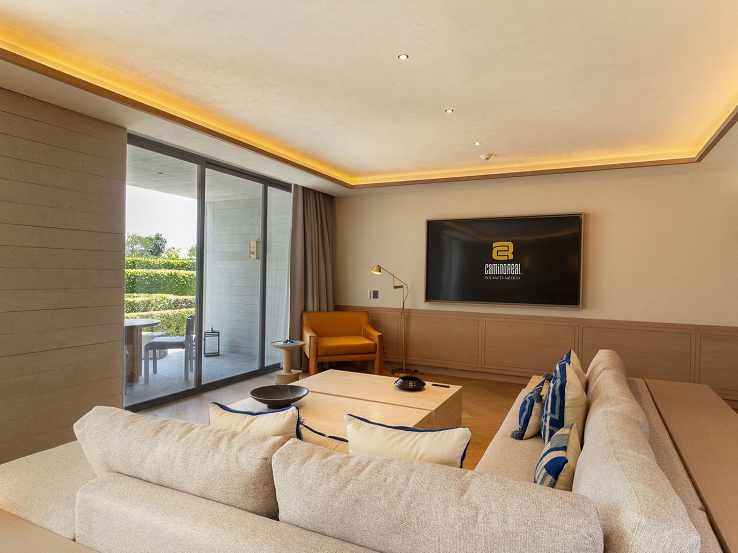 King Superior Viceroys Suite living area with a TV and sliding glass doors opens to a patio at Camino Real Polanco Mexico