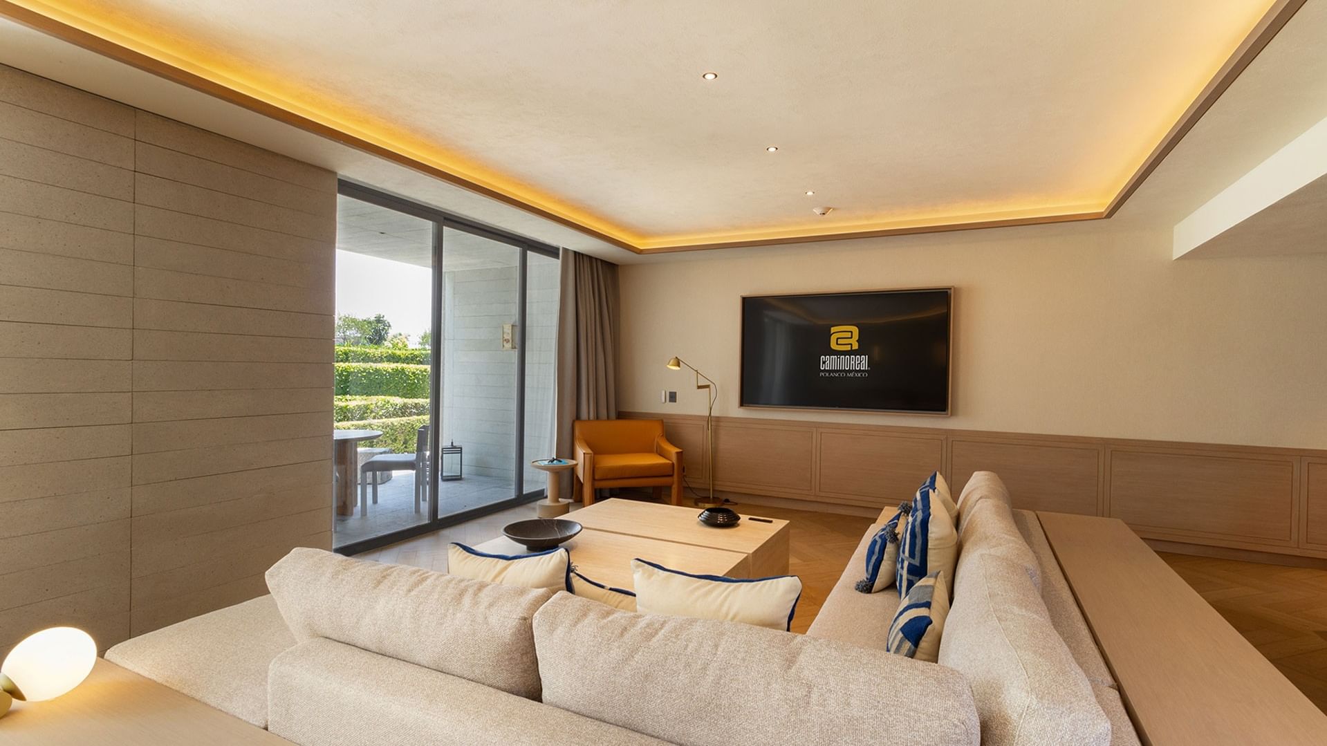 King Superior Viceroys Suite living area with a TV and sliding glass doors opens to a patio at Camino Real Polanco Mexico