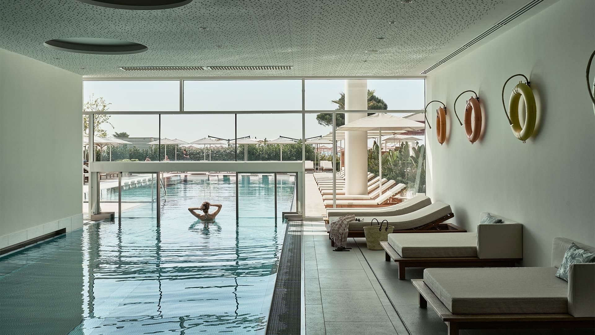 Interior of In- and Outdoorpools with loungers in Acquapura Blue.Horizon Spa at Falkensteiner Hotel & Spa Jesolo