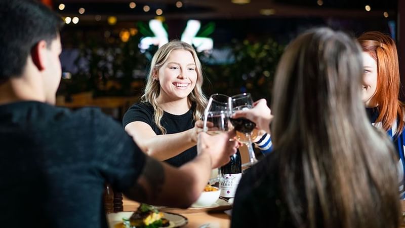 Kelly's Bar + Kitchen group with wine