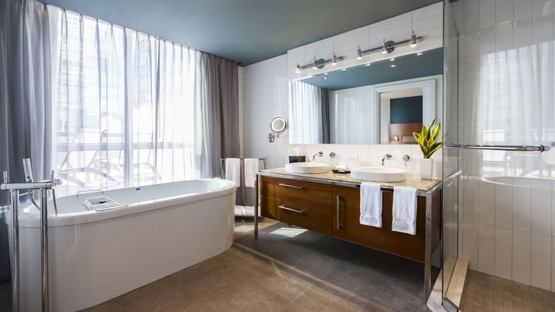 Bathroom with bathtub and vanity area in Penthouse Suite Sainte-Catherine at Warwick Le Crystal