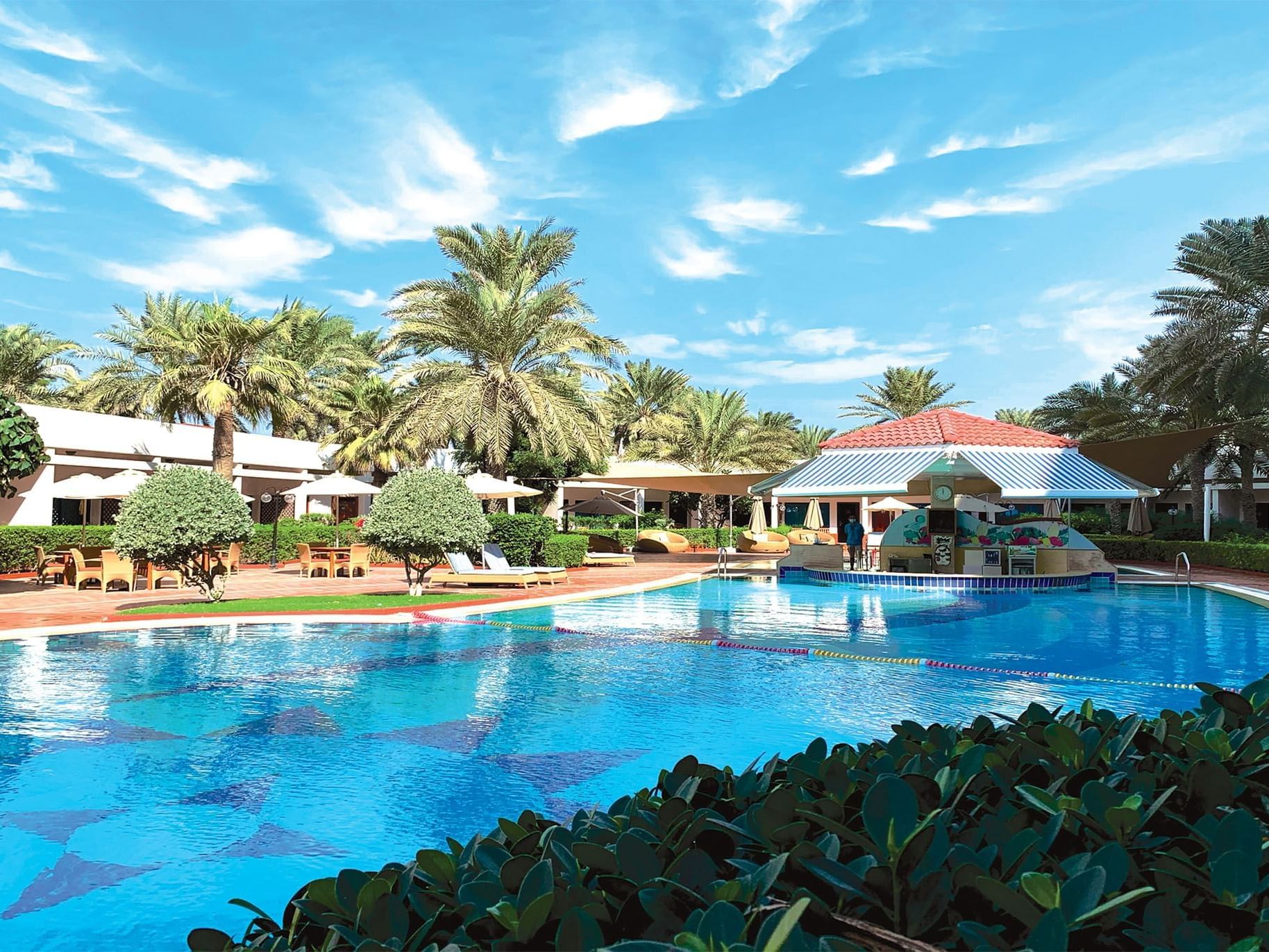 The exterior view of the pool bar area at Ajman Hotel