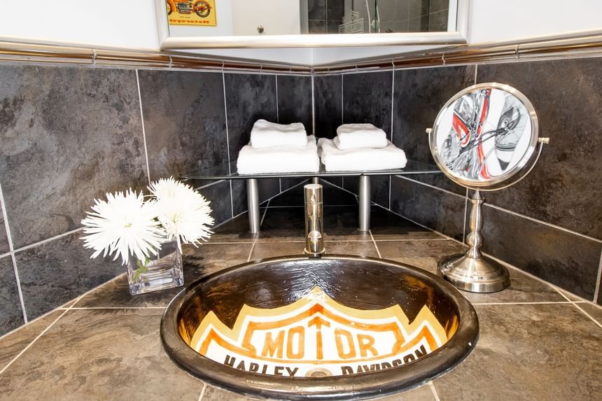 sink with custom harley davidson logo painted on, makeup mirror 