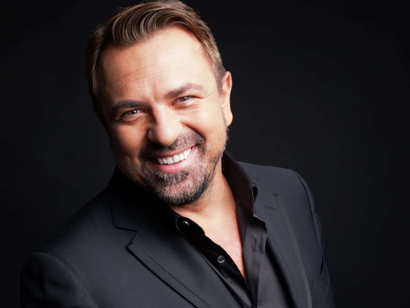 Portrait of a man in black suite at Ana Hotels