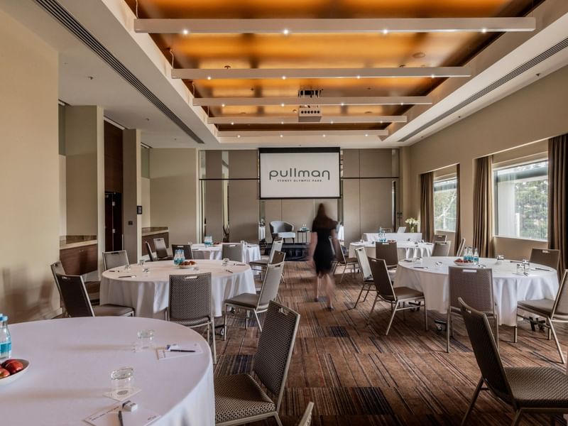 Echelon event room with round tables and chairs at Pullman Sydney Olympic Park.
