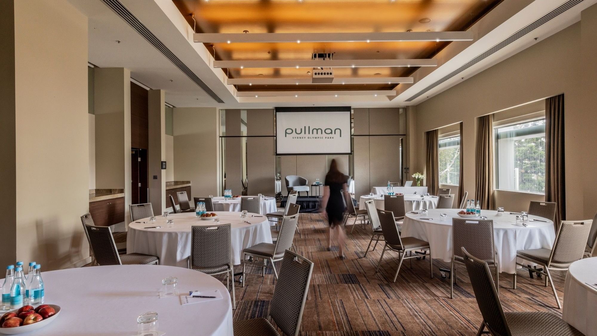 Echelon event room with round tables and chairs at Pullman Sydney Olympic Park.