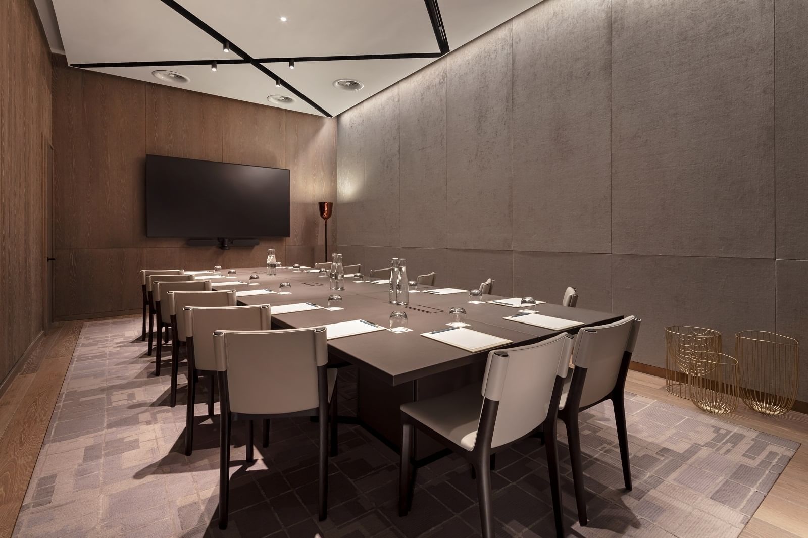 Tate Britain meeting room at The Londoner Hotel, with chairs arranged neatly facing a TV
