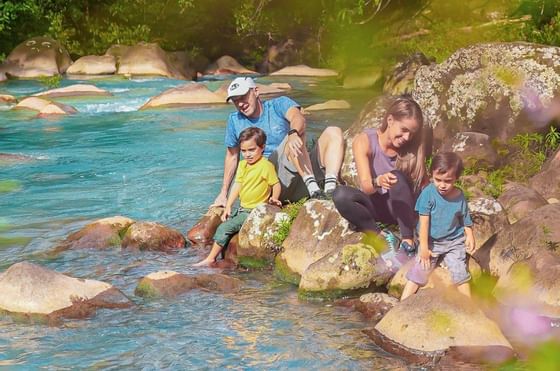 A family near a river bank near Rio Celeste