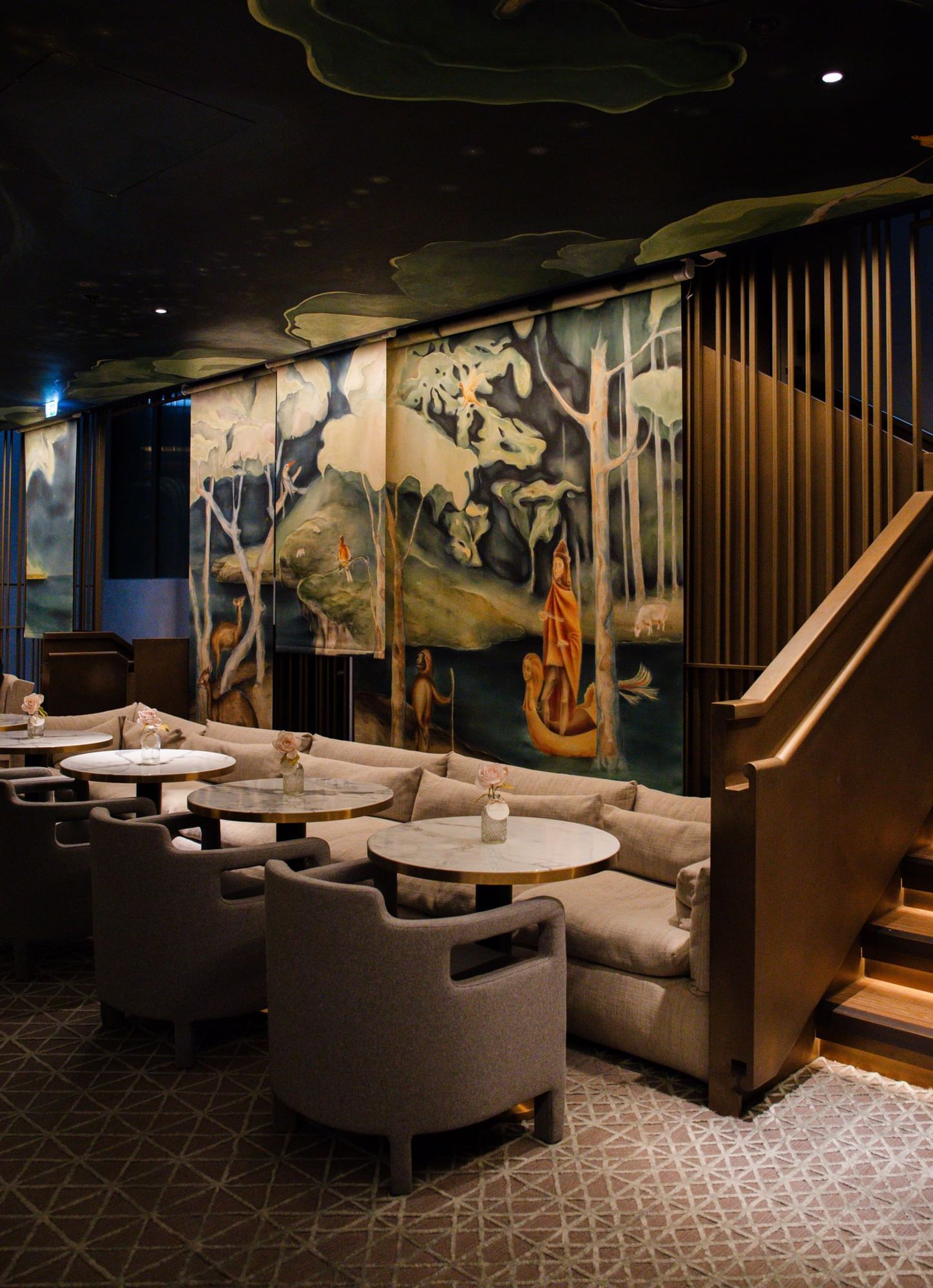 Elegant bar and lounge with artistic murals and comfortable seating, a cozy spot at The Londoner Hotel