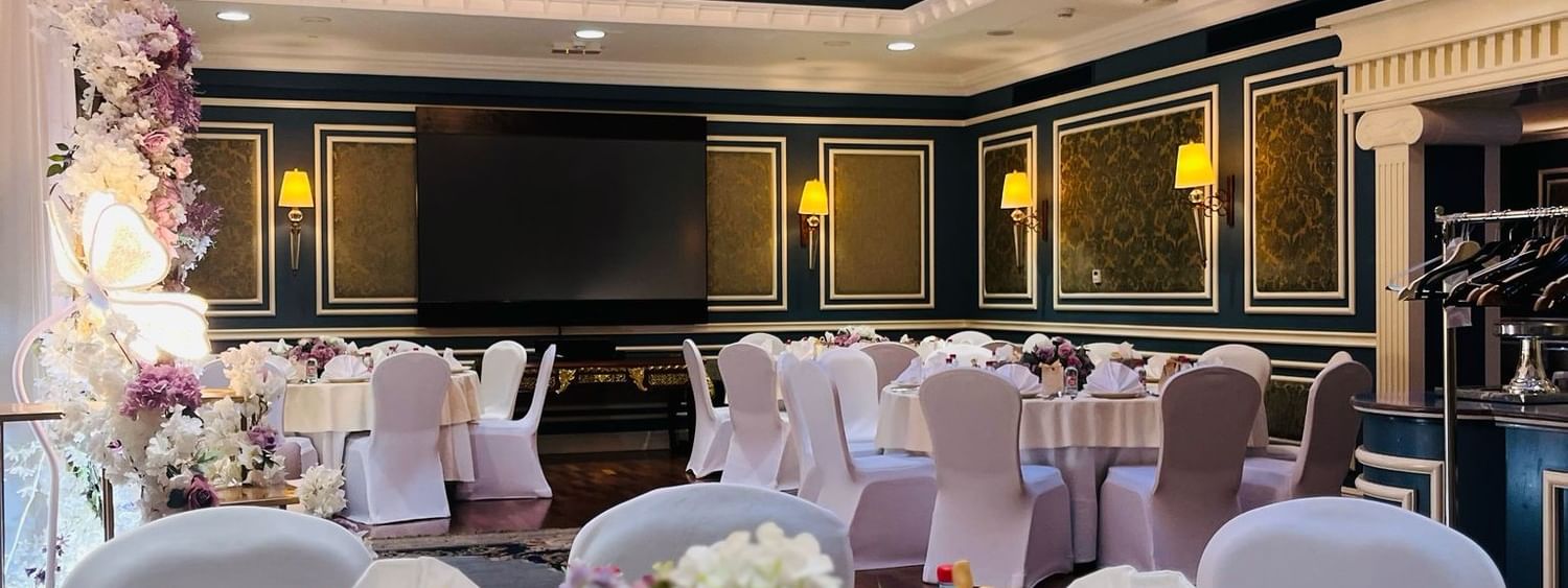Elegantly decorated Blue Room event space with chandelier at Warwick Doha
