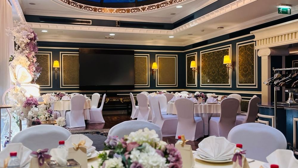 Elegantly decorated Blue Room event space with chandelier at Warwick Doha.