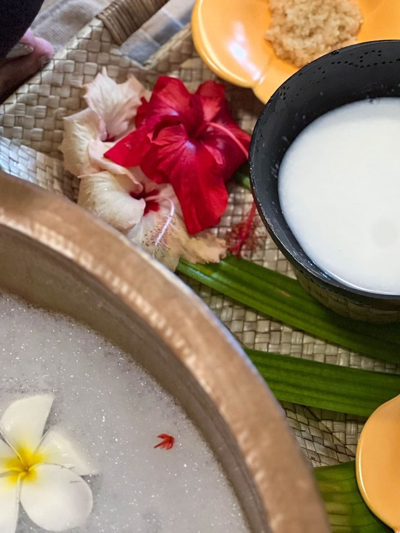Bowl of milk with flower petals and tropical flowers at The Joy Spa in The Naviti Resort, Korolevu