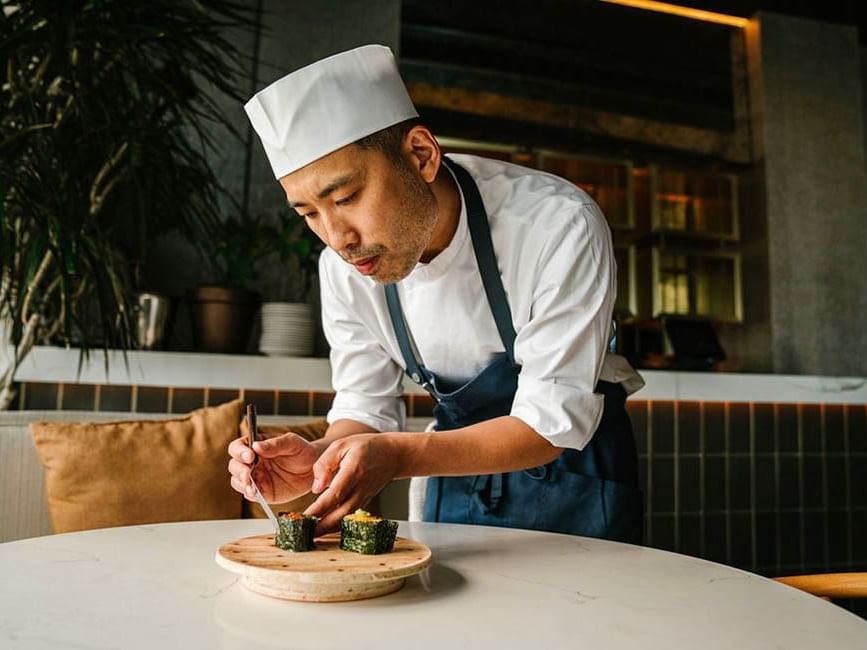 Chef plating a dish in Saishin at Gansevoort Meatpacking NYC