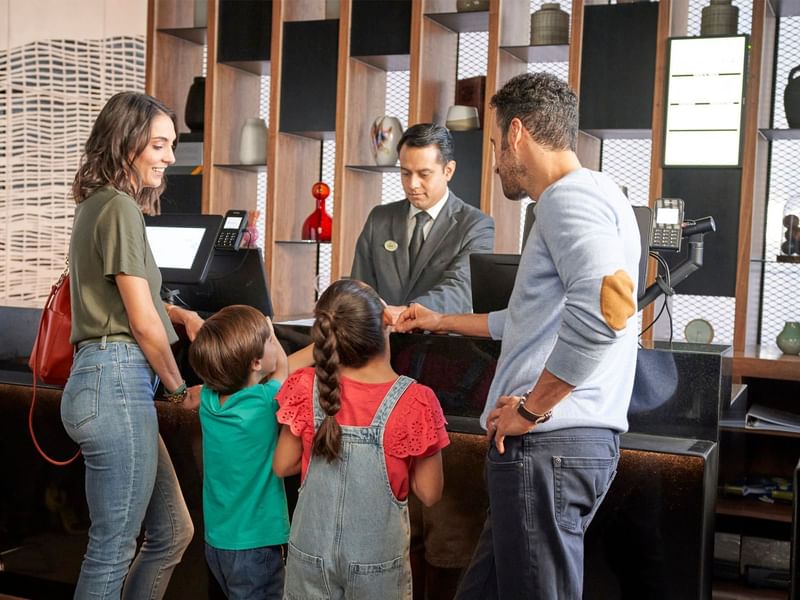 Family checking in at Grand Fiesta Americana's reception desk