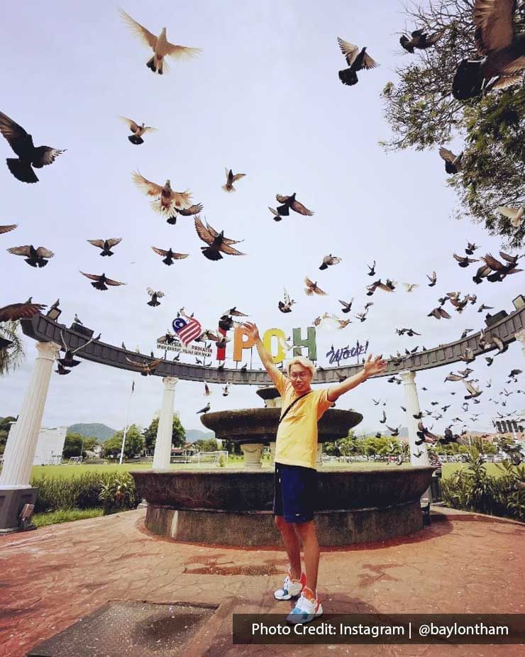 A man was taking a picture at Ipoh Padang - Lexis Suites Penang