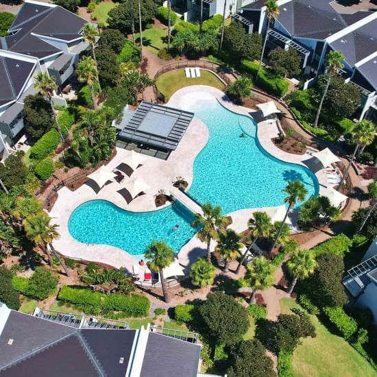 Aerial shot of lagoon pool with gardens surrounding at Pullman Magenta Shores