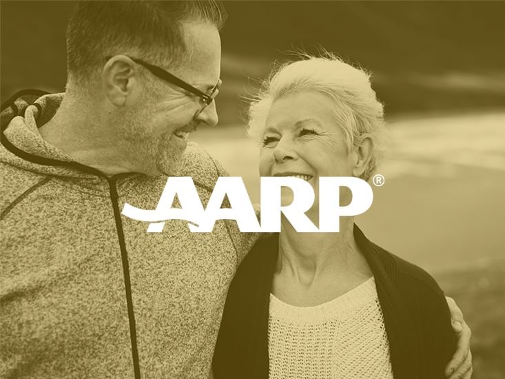 AARP logo with a couple in the background at Clinton Hotel 