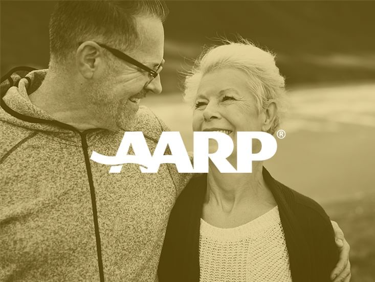 AARP logo with a couple in the background at Clinton Hotel