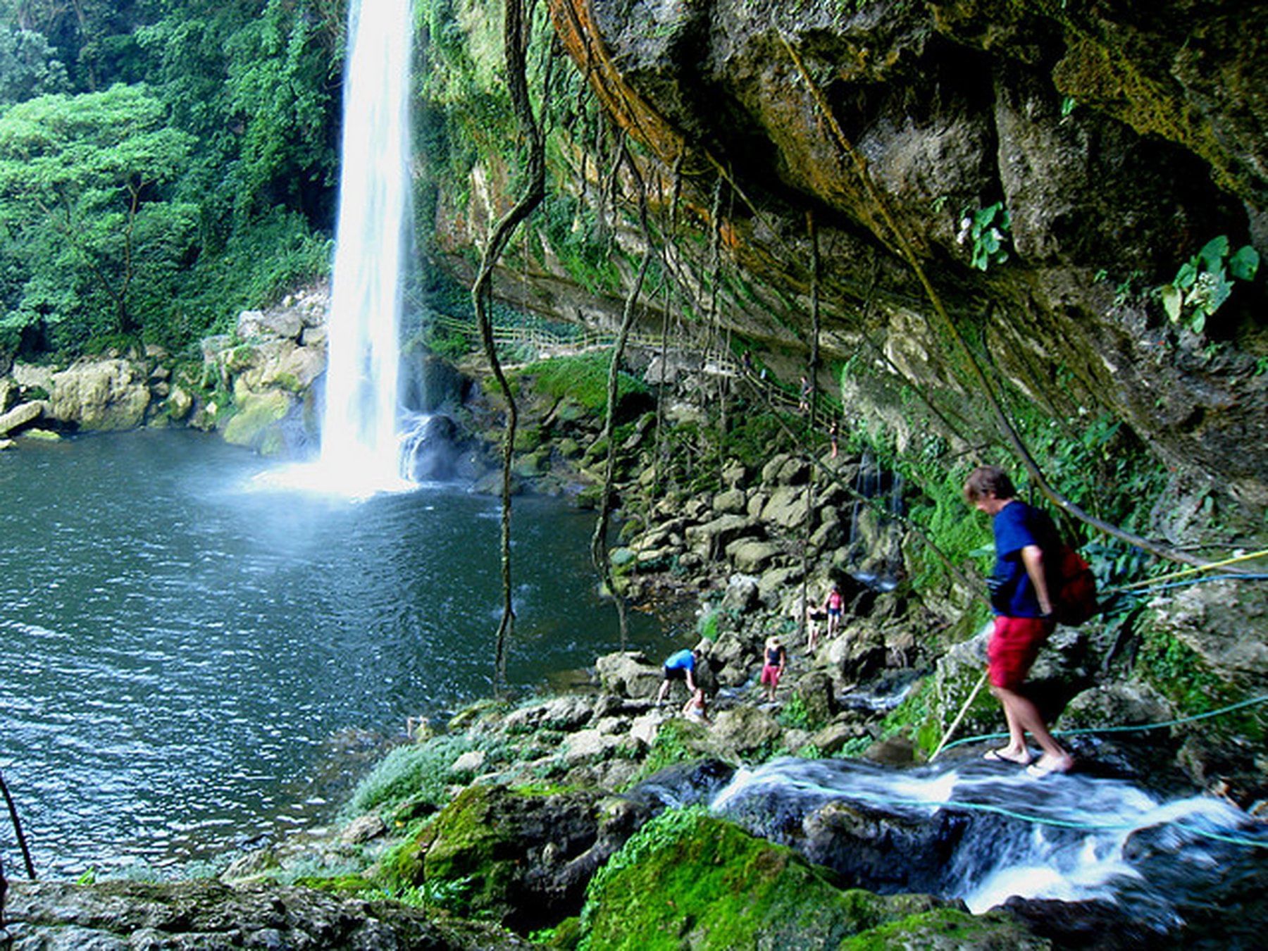 a group of people by a waterfall