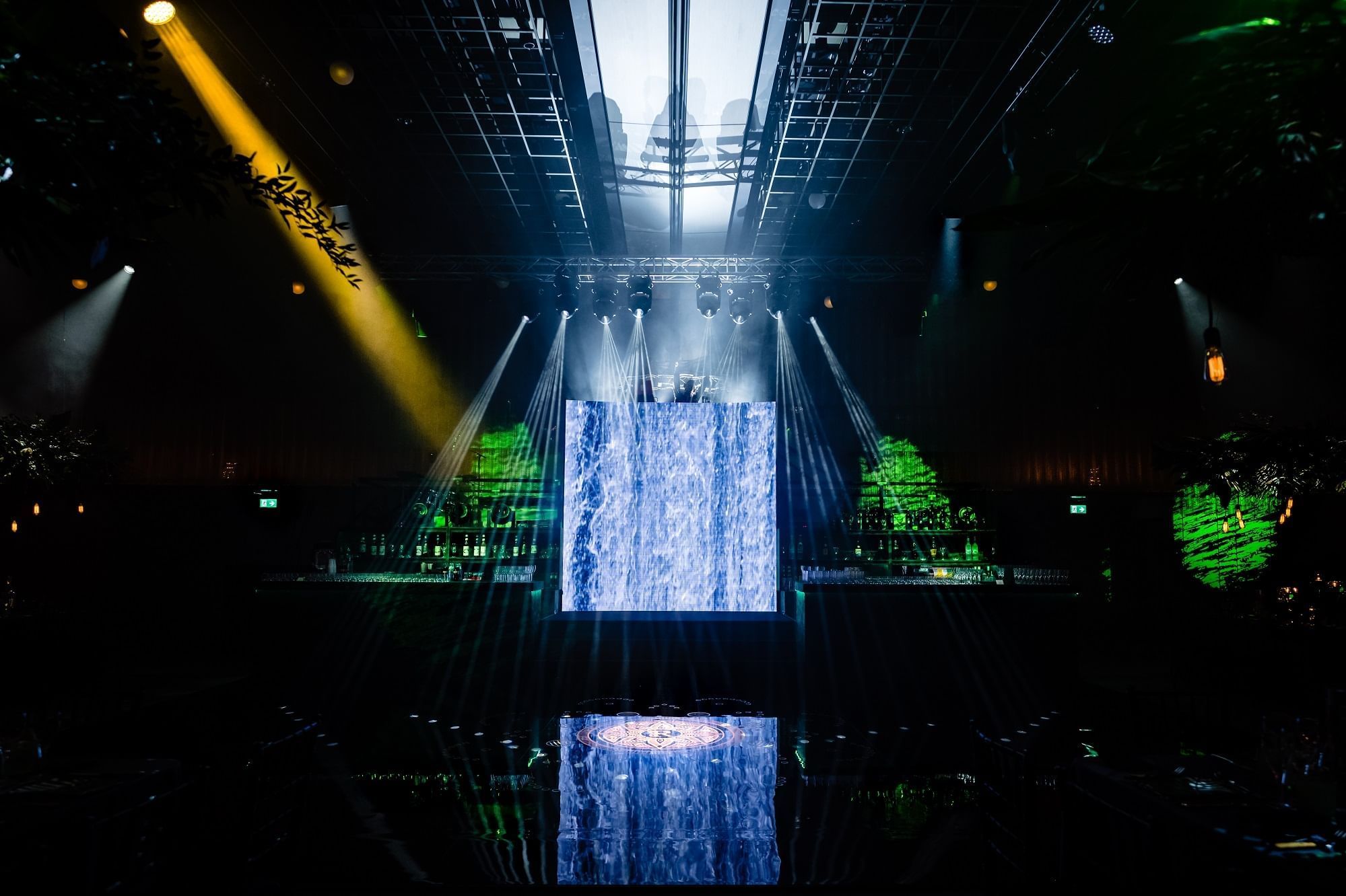 Stage with bright light setup and a big screen in The Ballroom at The Londoner Hotel