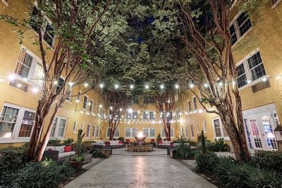 Strings of lights light up a courtyard at Artmore Hotel