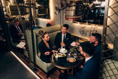 People dining in a Mott 32 at Paradox Hotel Vancouver