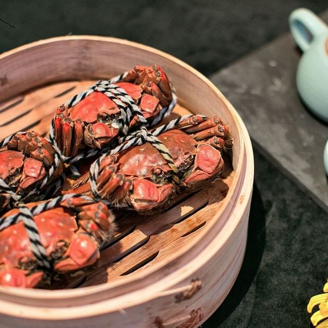 Closeup of tied crabs in a bowl at Amara Hotels