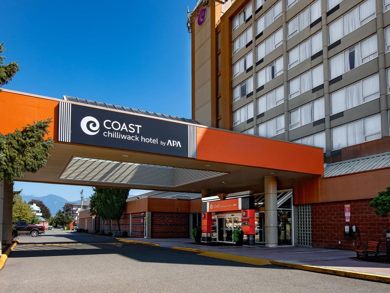 Main entrance and exterior of Coast Chilliwack Hotel by APA on a sunny day.