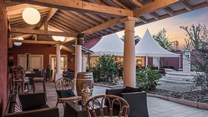 Outdoor dining area at Hotel Le Pillebois in Originals Hotels