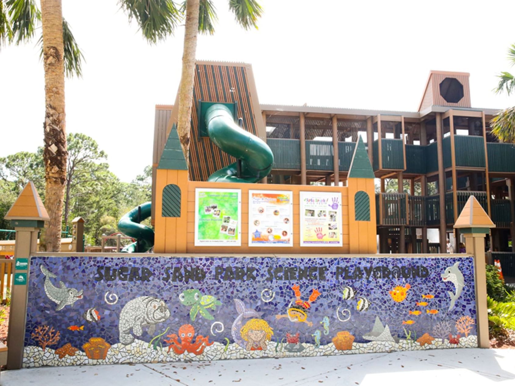 Exterior view of children's play area & a mural art in Sugar Sand Park near Ocean Lodge Boca Raton