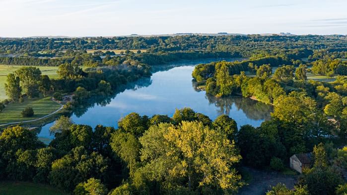 Aerial view of a forest lake near Village Hotels Swindon
