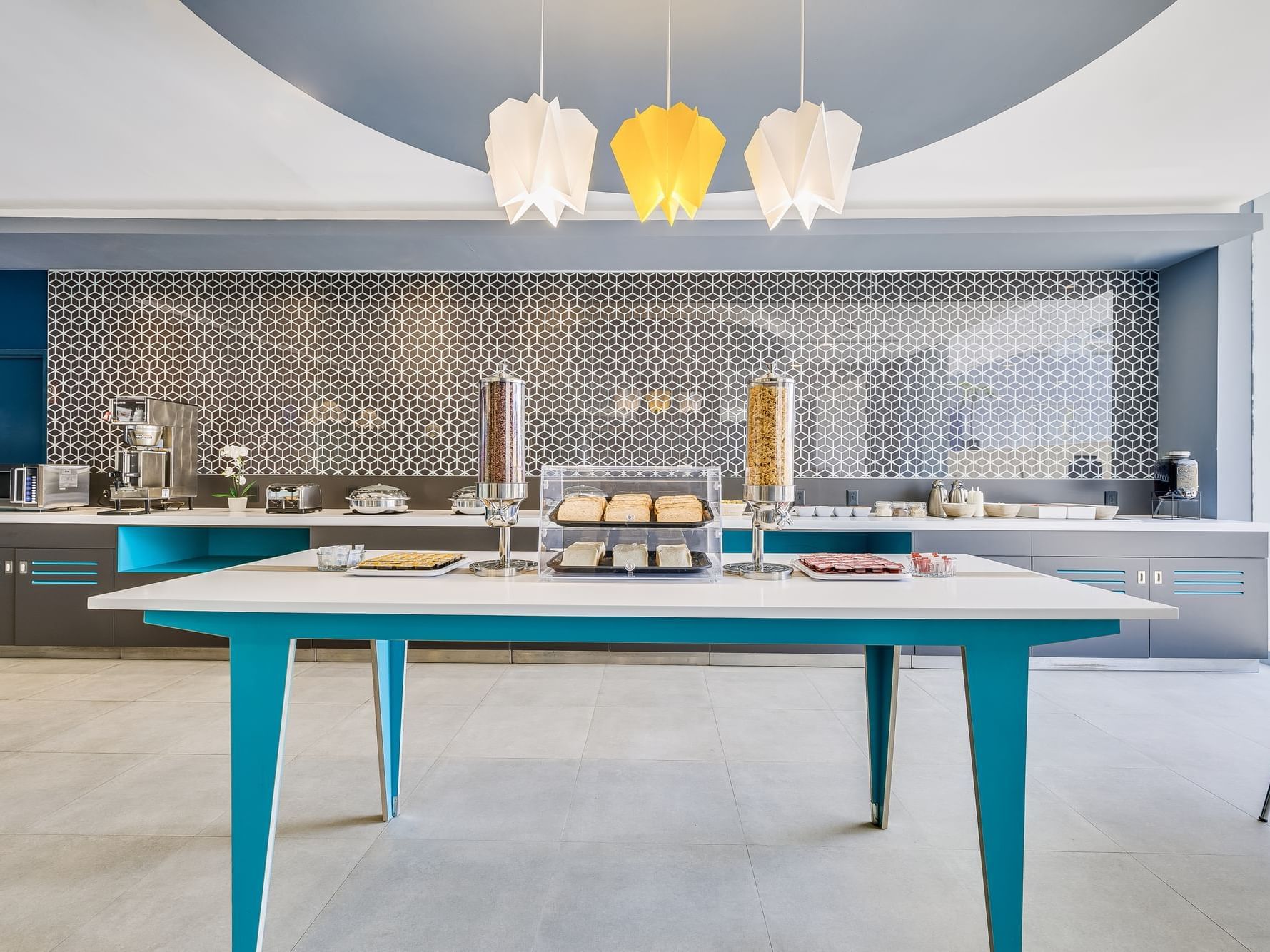 Modern kitchen with dining table and coffee machine at One Hotels